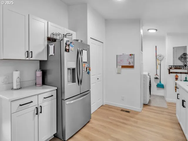 a kitchen with stainless steel appliances a refrigerator sink and cabinets