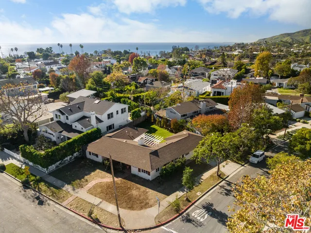 an aerial view of a residential houses with outdoor space