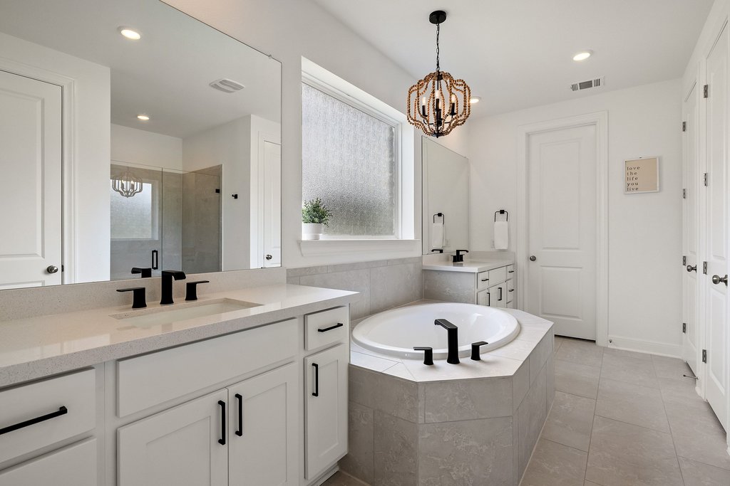 365 Pear Tree Lane Austin, TX 78737 - Photo 21 of 39 a bathroom with a sink a bathtub a mirror and a shower