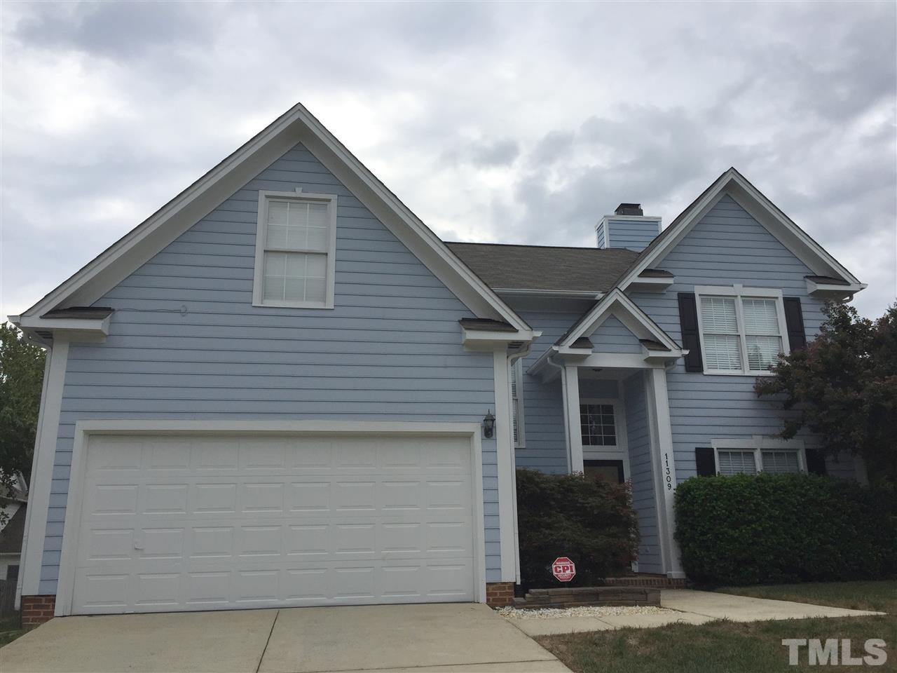 11309 North Radner Way Raleigh, NC 27613 - Photo 1 of 25 a front view of a house with garage
