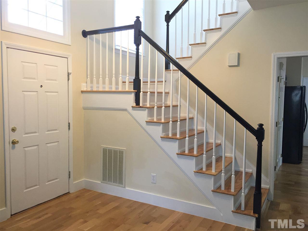 11309 North Radner Way Raleigh, NC 27613 - Photo 2 of 25 a view of staircase with wooden floor and white walls