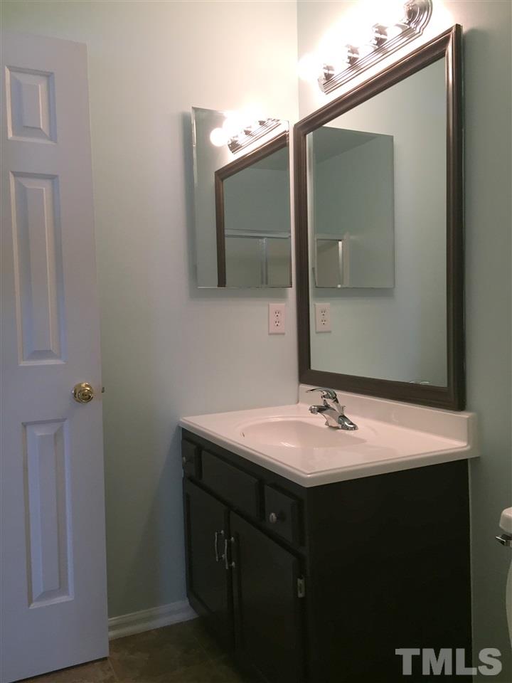 11309 North Radner Way Raleigh, NC 27613 - Photo 14 of 25 a bathroom with a sink and a mirror