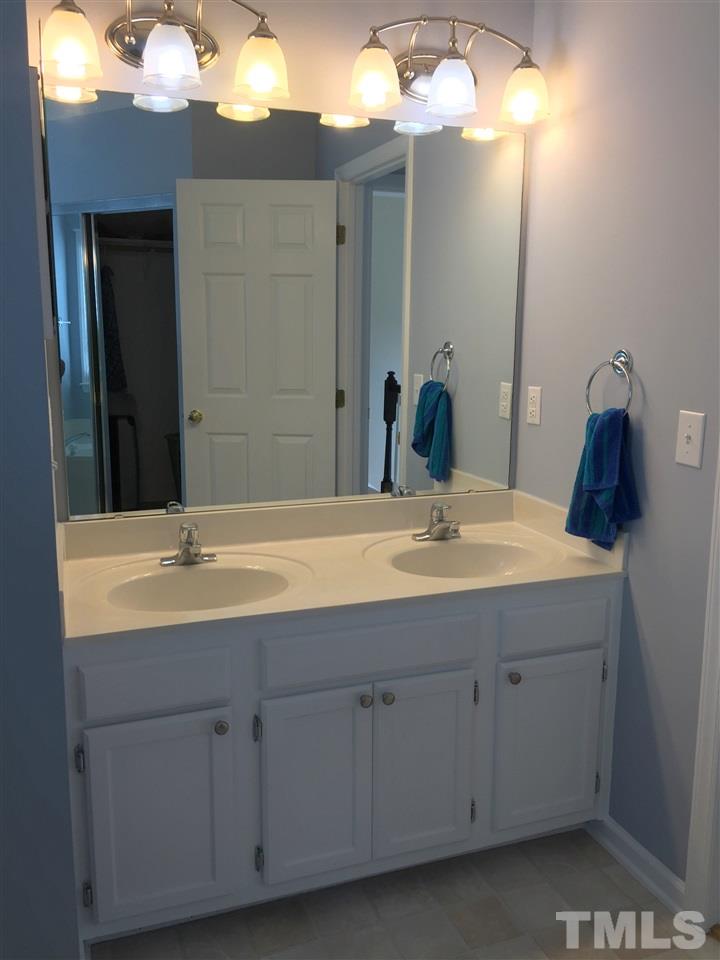 11309 North Radner Way Raleigh, NC 27613 - Photo 18 of 25 a bathroom with a sink and a mirror