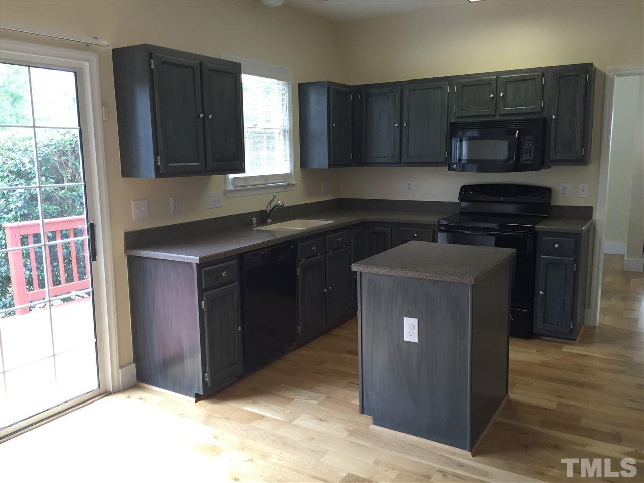 11309 North Radner Way Raleigh, NC 27613 - Photo 3 of 25 a kitchen with a sink and a stove top oven