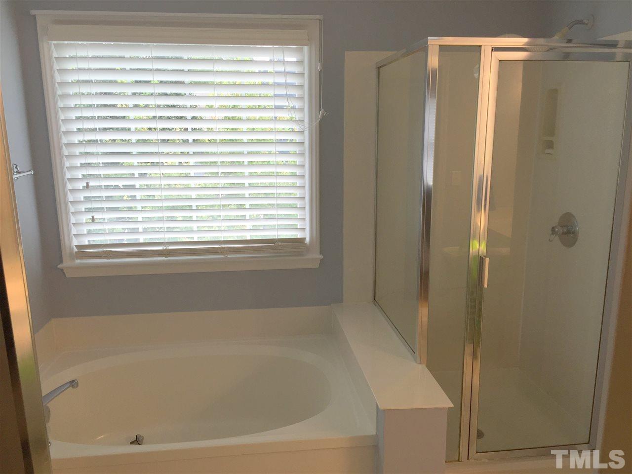 11309 North Radner Way Raleigh, NC 27613 - Photo 21 of 25 a bathroom with a bathtub and a shower