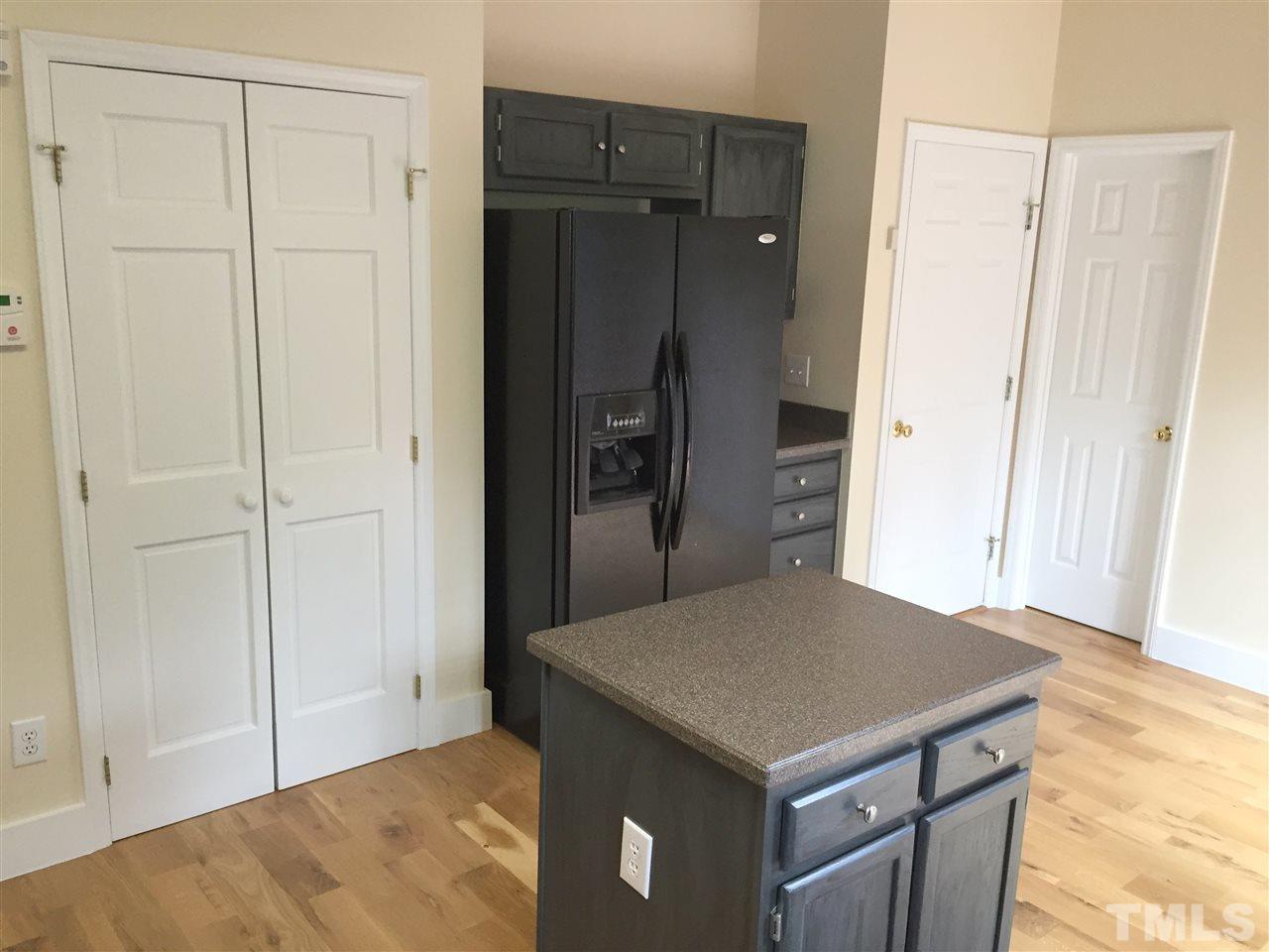 11309 North Radner Way Raleigh, NC 27613 - Photo 5 of 25 a kitchen with a table and refrigerator