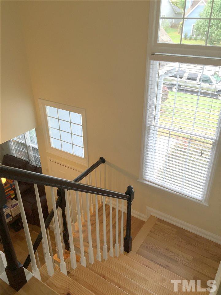 11309 North Radner Way Raleigh, NC 27613 - Photo 10 of 25 a view of an empty room with wooden floor and a window