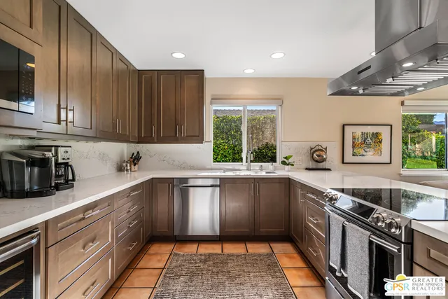 a kitchen with a sink stove top oven and cabinets