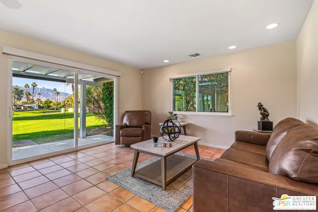 a living room with furniture and a rug