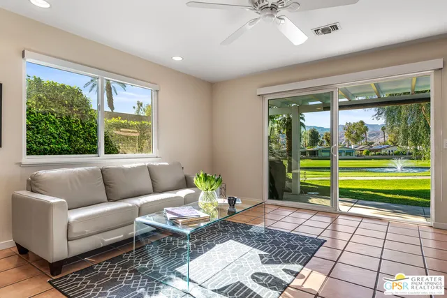 a kitchen with stainless steel appliances kitchen island granite countertop a refrigerator a stove a sink dishwasher and white cabinets with wooden floor