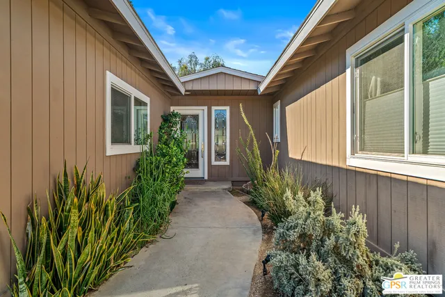 a hallway with a large window and refrigerator