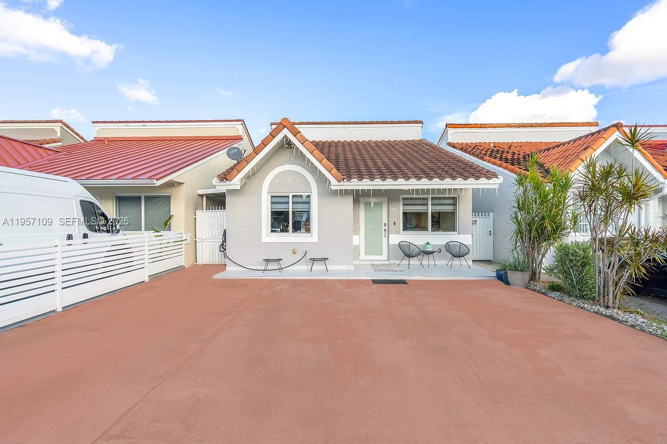 7531 West 29th Way, Unit 7531 Hialeah, FL 33018 - Photo 1 of 30 a front view of a house with a yard and porch