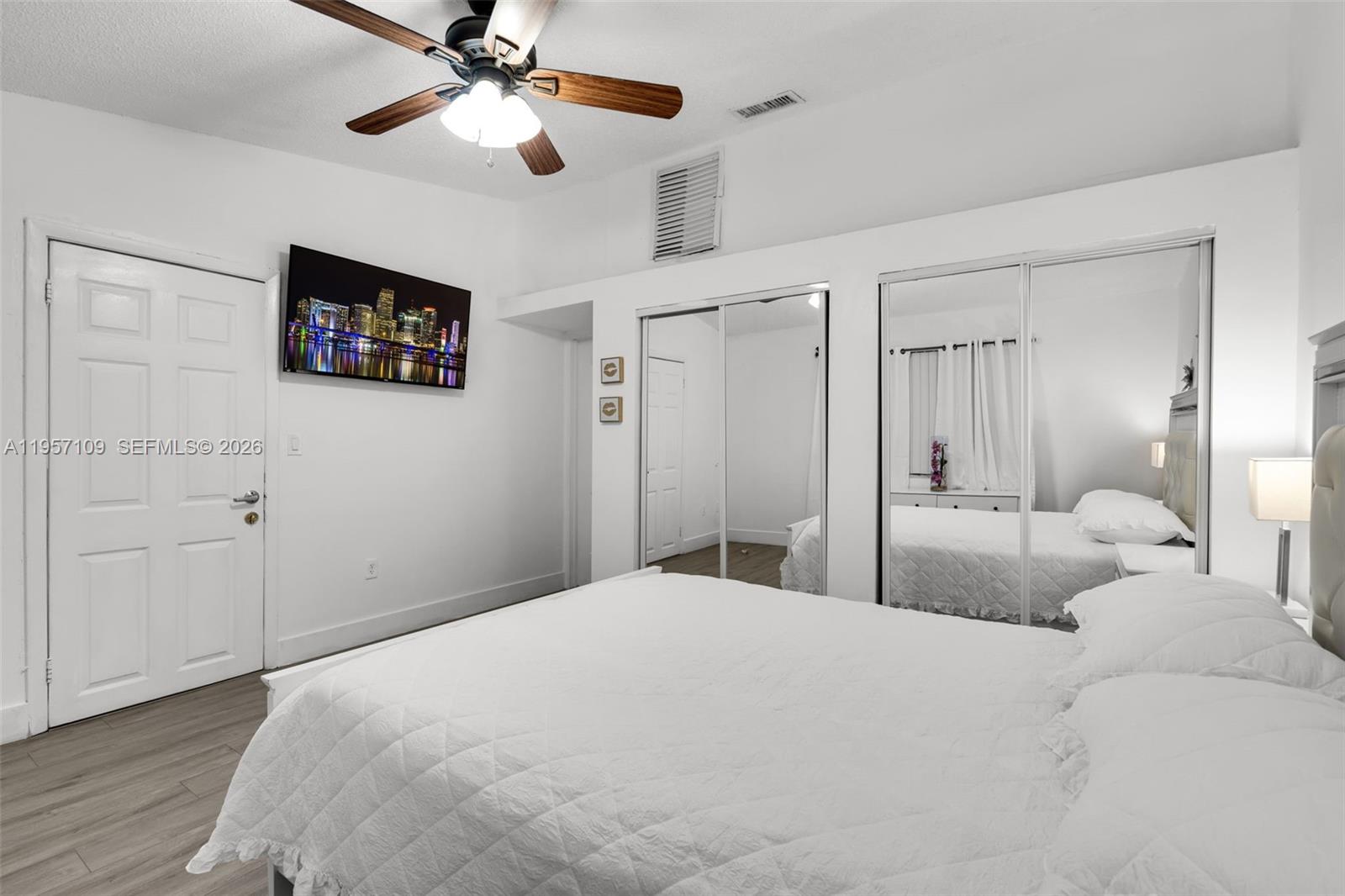 7531 West 29th Way, Unit 7531 Hialeah, FL 33018 - Photo 13 of 30 a bedroom with a bed and a ceiling fan