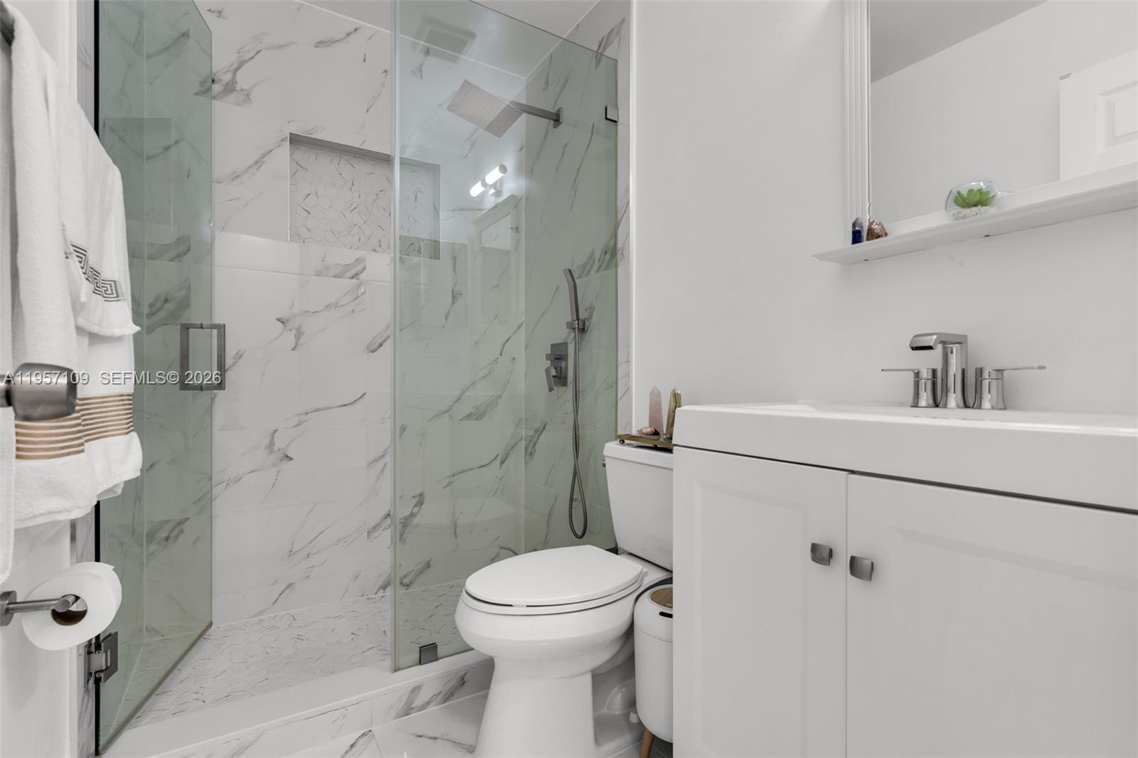7531 West 29th Way, Unit 7531 Hialeah, FL 33018 - Photo 19 of 30 a bathroom with a sink toilet and shower
