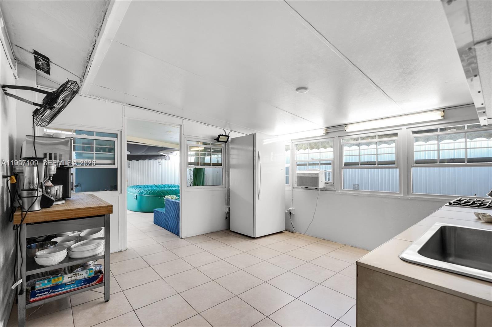 7531 West 29th Way, Unit 7531 Hialeah, FL 33018 - Photo 22 of 30 a kitchen with a sink and refrigerator