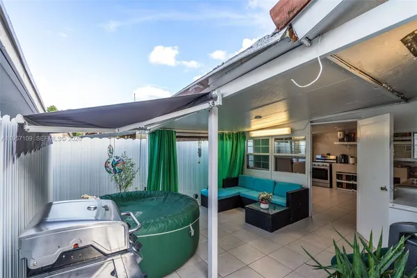 a view of a house with backyard and sitting area