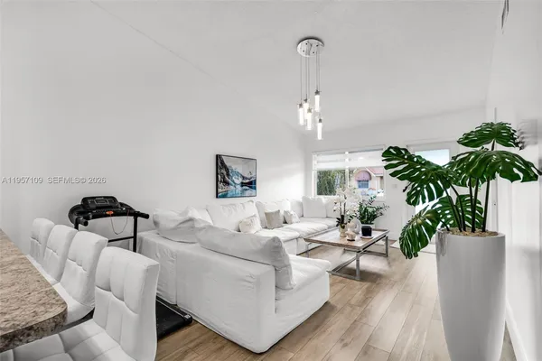a living room with furniture and a potted plant