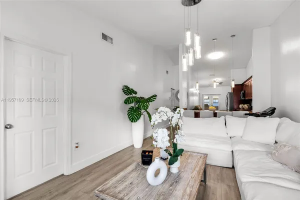 a living room with furniture and a chandelier