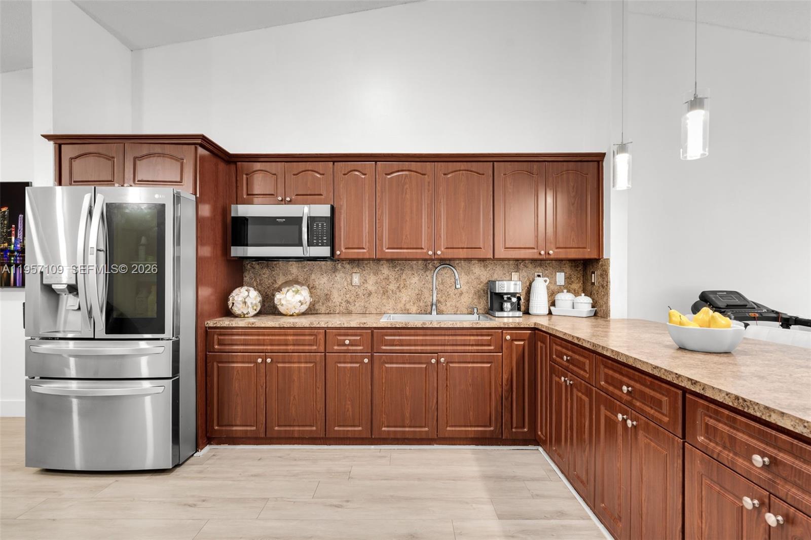 7531 West 29th Way, Unit 7531 Hialeah, FL 33018 - Photo 7 of 30 a kitchen with stainless steel appliances granite countertop a refrigerator and a sink