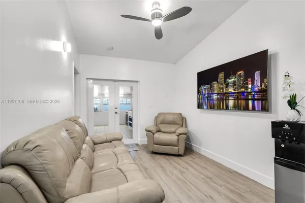 a living room with furniture and a flat screen tv