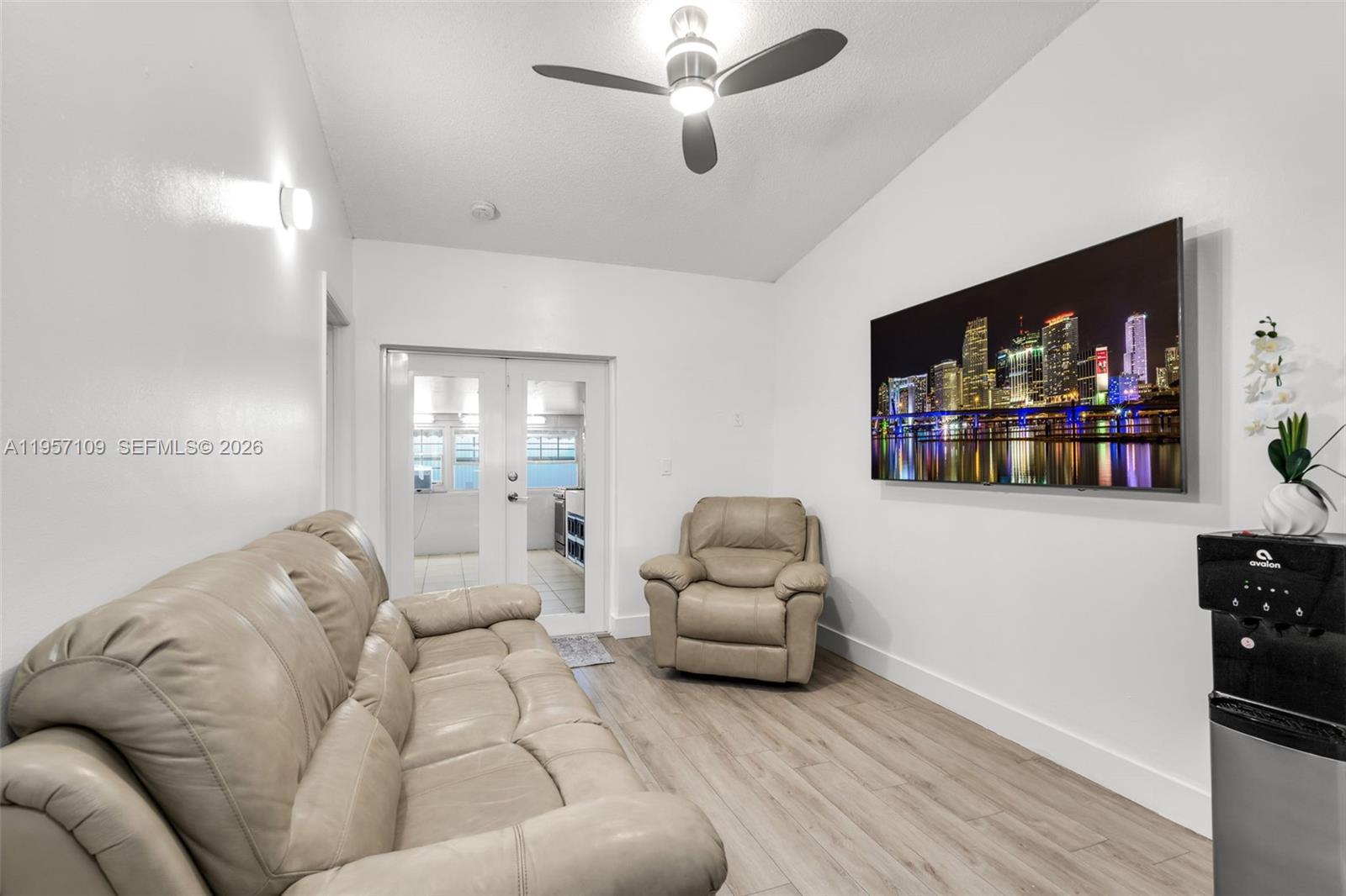 7531 West 29th Way, Unit 7531 Hialeah, FL 33018 - Photo 9 of 30 a living room with furniture and a flat screen tv