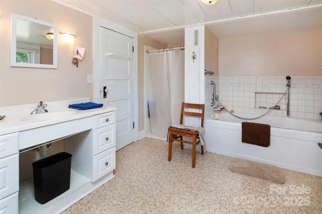 a spacious bathroom with a sink double vanity and a mirror