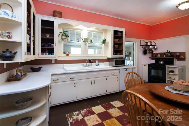 a kitchen with sink cabinets and dining table