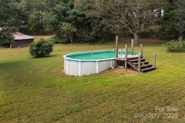 a view of a backyard with swimming pool