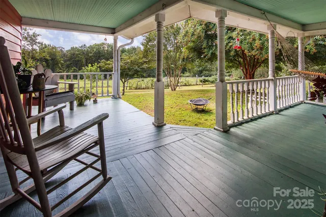 a view of a balcony with chairs and wooden floor