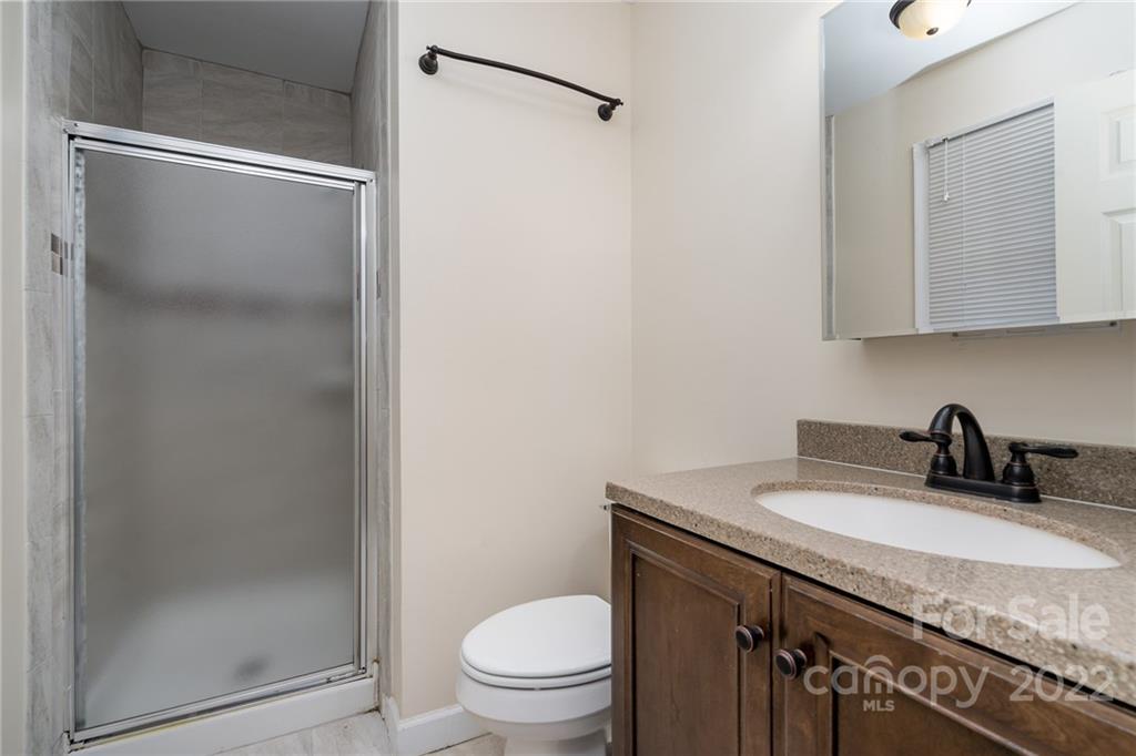 1500 Rama Road Charlotte, NC 28211 - Photo 17 of 25 a bathroom with a granite countertop sink toilet and a mirror