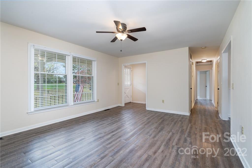 1500 Rama Road Charlotte, NC 28211 - Photo 3 of 25 a view of an empty room with wooden floor and a window