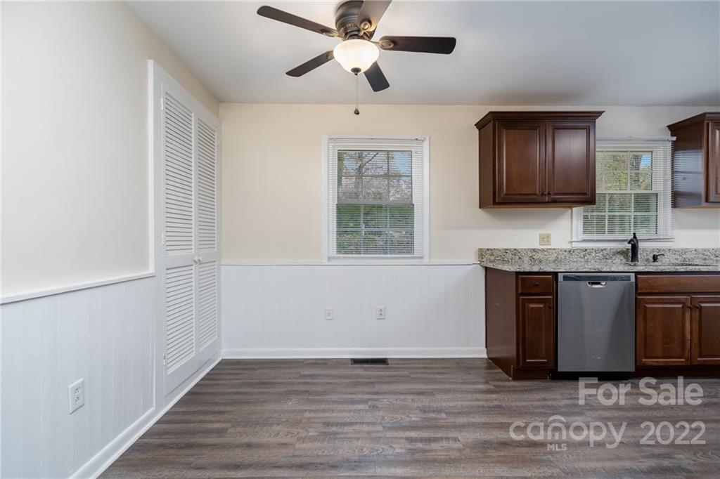 1500 Rama Road Charlotte, NC 28211 - Photo 6 of 25 a kitchen with stainless steel appliances granite countertop a sink and a stove with wooden floor