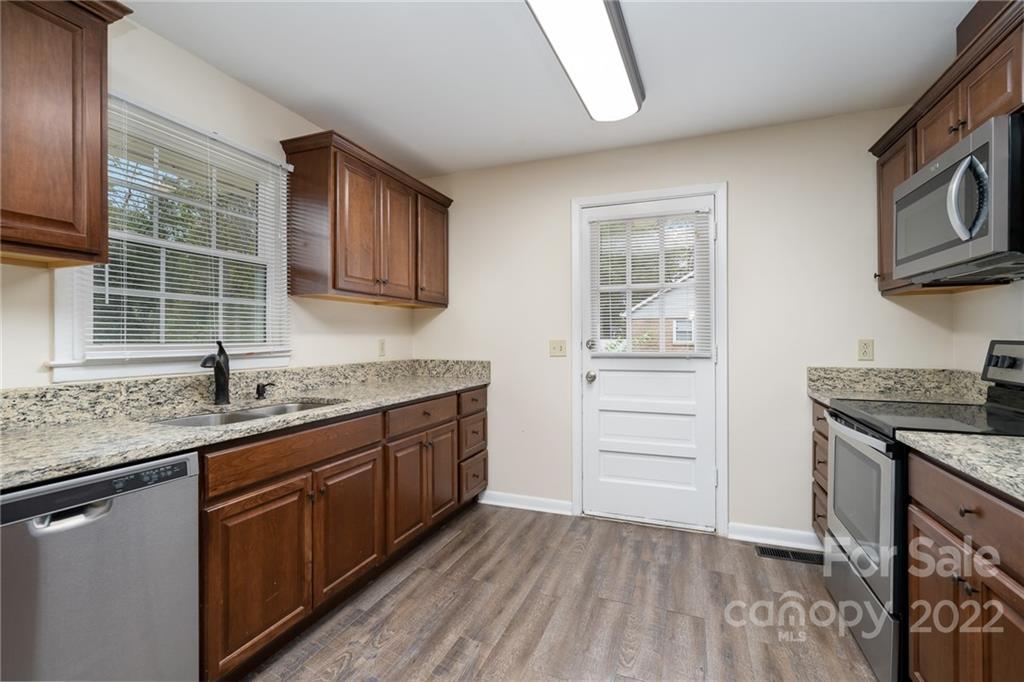 1500 Rama Road Charlotte, NC 28211 - Photo 8 of 25 a kitchen with granite countertop stainless steel appliances a stove sink and cabinets