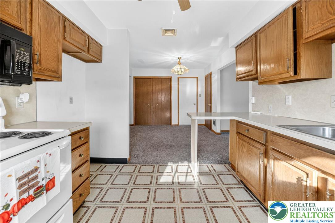 1026 Oak Street Coplay, PA 18037 - Photo 11 of 27 a kitchen with stainless steel appliances granite countertop a stove a sink and a refrigerator