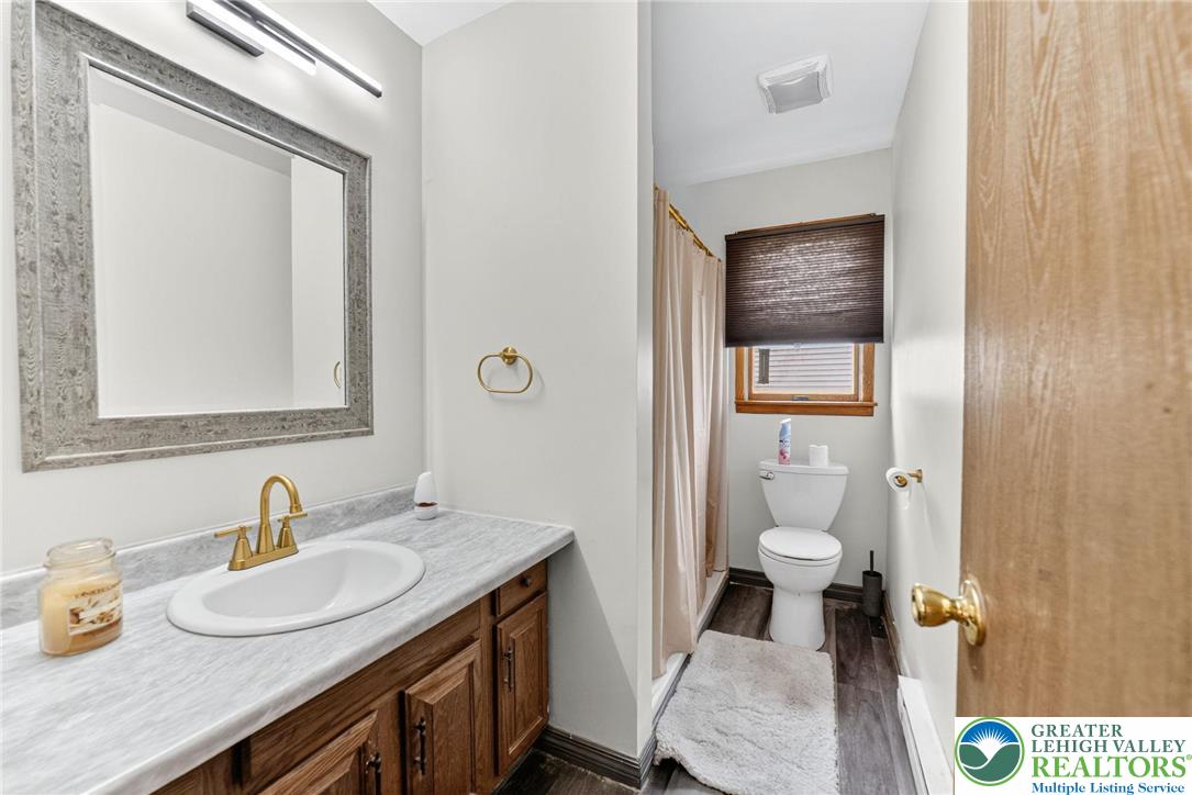 1026 Oak Street Coplay, PA 18037 - Photo 14 of 27 a bathroom with a granite countertop sink toilet and mirror