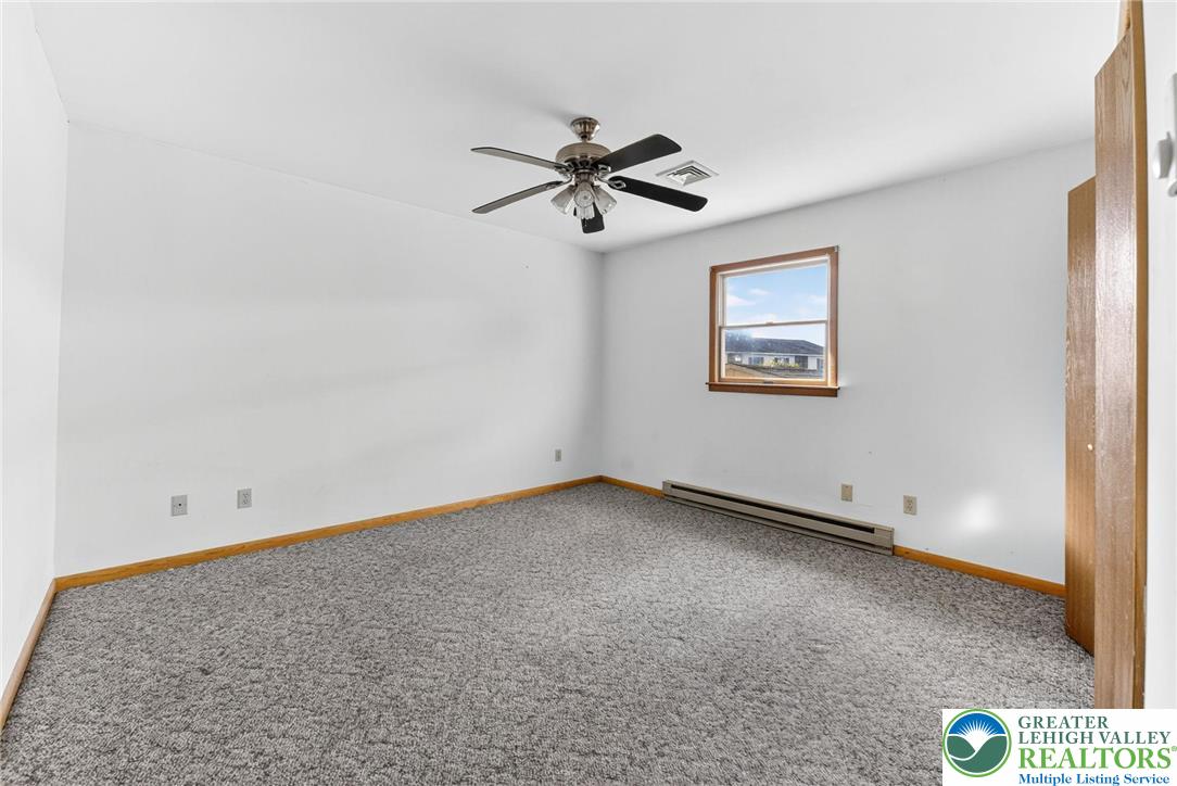 1026 Oak Street Coplay, PA 18037 - Photo 15 of 27 an empty room with windows and fan
