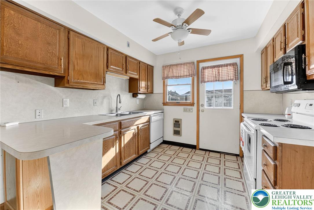 1026 Oak Street Coplay, PA 18037 - Photo 10 of 27 a kitchen with a sink a stove and cabinets