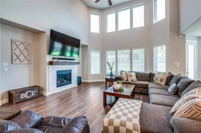 a living room with furniture a flat screen tv and a fireplace