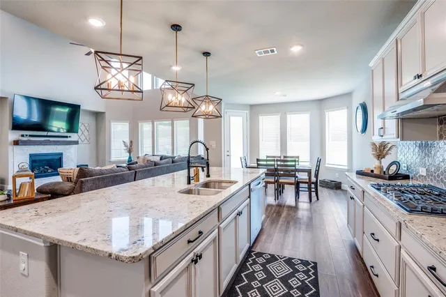 a kitchen with sink stove and cabinets