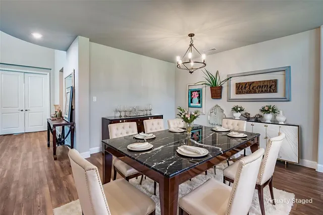 a view of a dining room with furniture wooden floor and chandelier