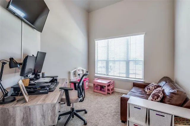 a livingroom with workspace and a window