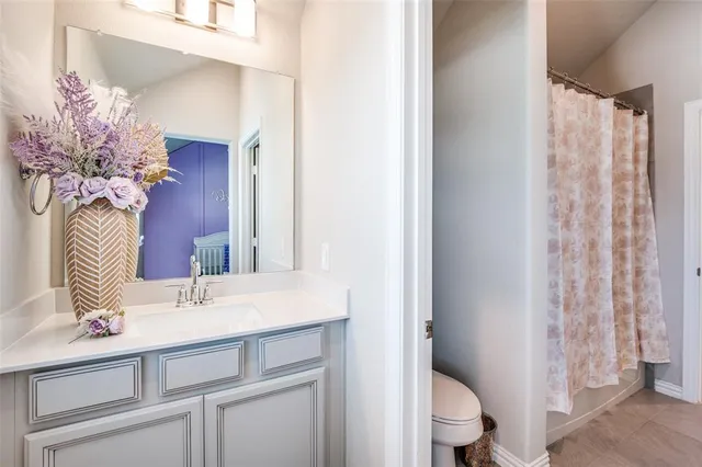 a bathroom with a sink a toilet and a mirror