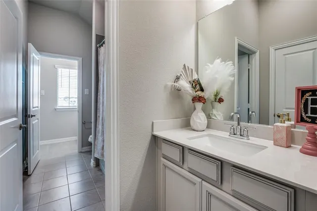 a bathroom with a sink vanity and a mirror