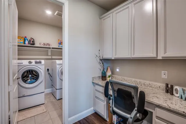 a utility room with sink dryer and washer