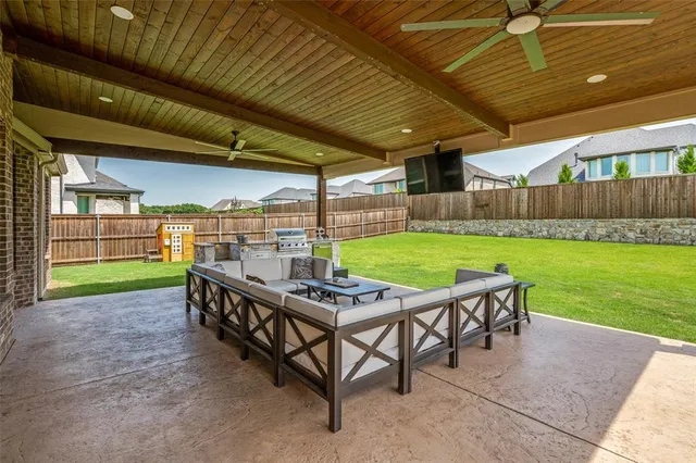 a view of a backyard with wooden floor and outdoor seating