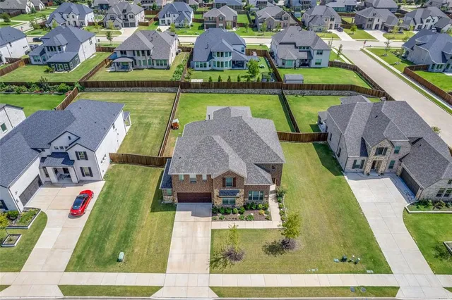 an aerial view of a house with a garden and swimming pool