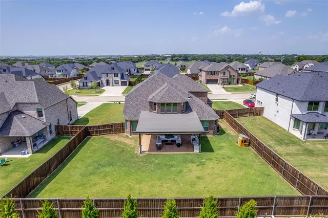 an aerial view of a house with a garden and a swimming pool