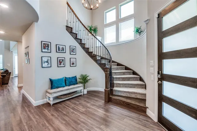a view of entryway and hall with wooden floor