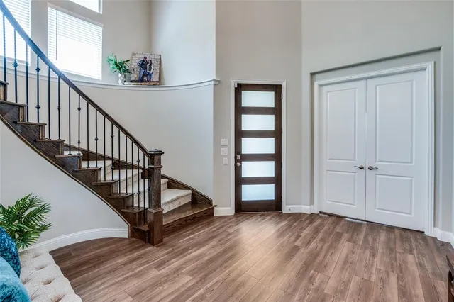 a view of an entryway with wooden floor and stairs