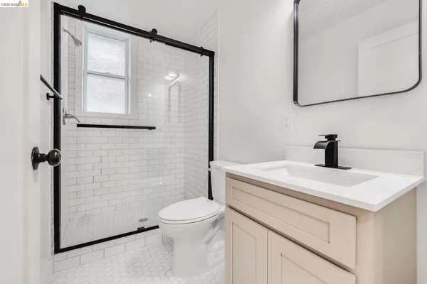 a bathroom with a sink a toilet and mirror